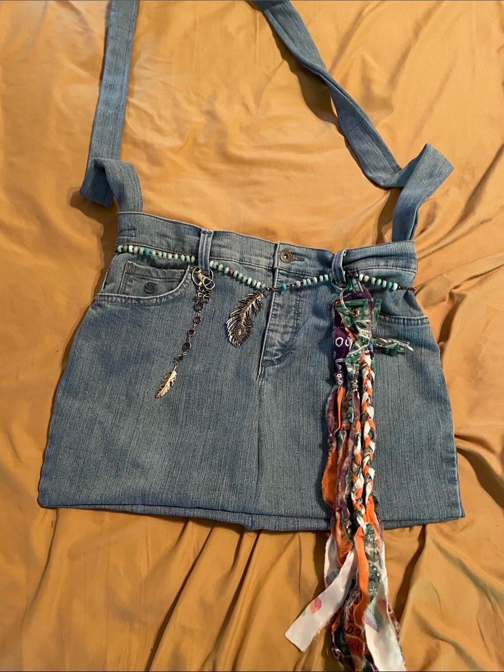 Handcrafted denim crossbody bag with embellishments and Raes Love Swag